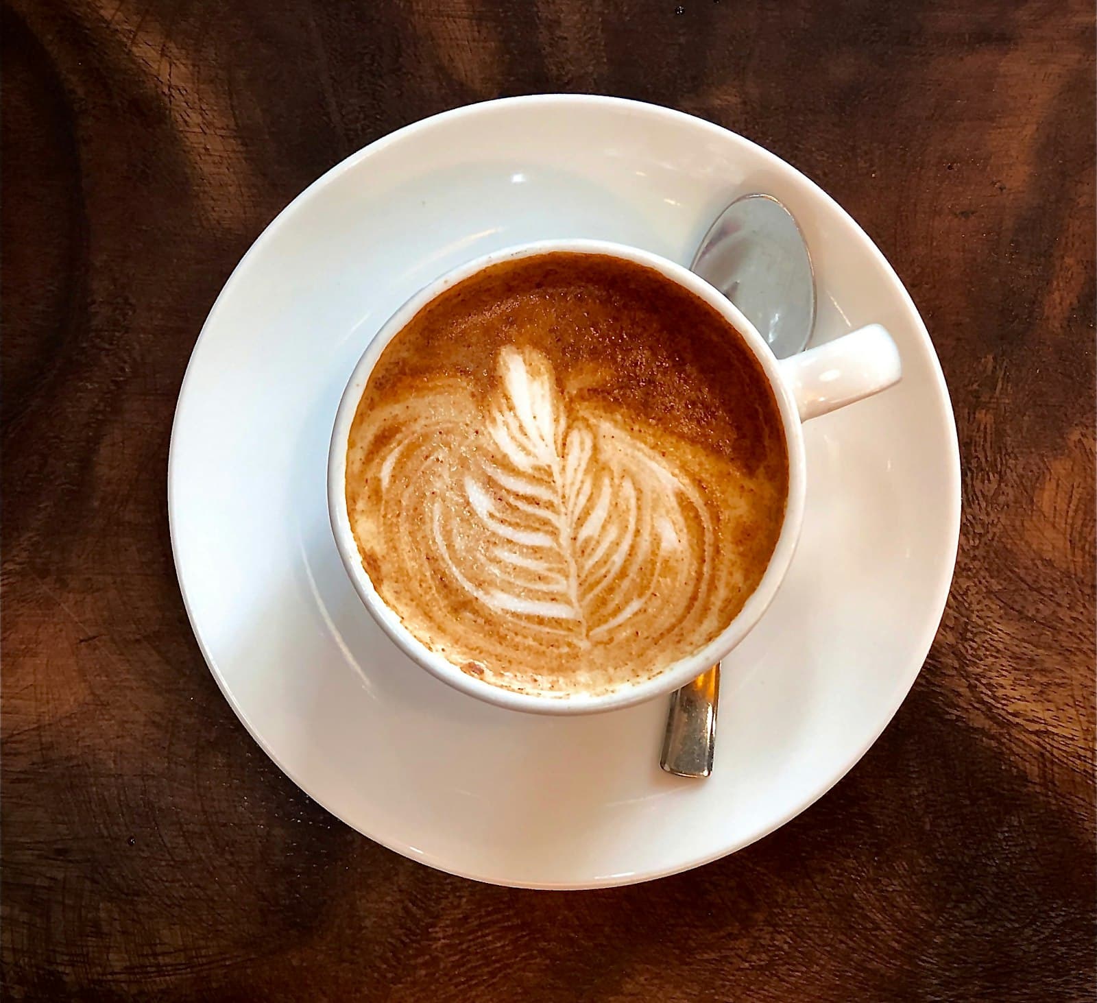Frothed milk being poured into coffee